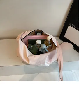 Top view of pink canvas tote bag showing spacious interior with water bottle and tablet
