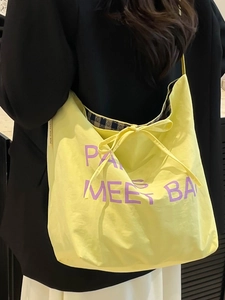 Large pale yellow nylon tote bag with purple Paris lettering and bow tie detail