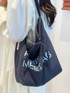 Minimalist black oversized tote bag with Paris embroidery and drawstring closure for women