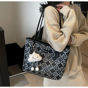 Détail d'un sac cabas géométrique noir et blanc élégant avec un charmant nuage en peluche