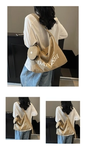 Detail of khaki canvas hobo bag with adjustable strap and small matching round pouch