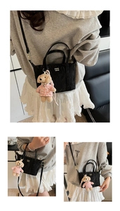 Détail du mini sac cabas noir avec pendentif ours rose et logo doré imprimé