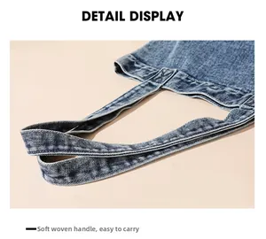 Detail view of durable denim tote bag with soft woven ribbon handles for comfortable carrying