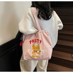 Detailed close-up of pink nylon tote with 3D embroidery featuring a cute cartoon bear