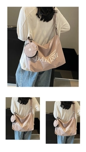 Detail of canvas shoulder bag with adjustable strap and small matching round coin purse
