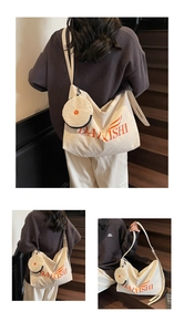 Detail of off-white canvas crossbody bag with orange logo and mini round coin purse