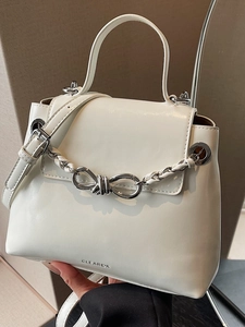 White leather crossbody bag with silver chain and bow clasp decoration for women
