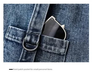 Detail of denim tote bag showing a front pocket with D-ring and sunglasses storage