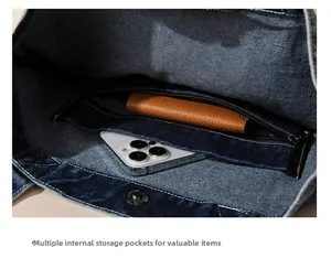 Detail showing inner pockets and zipper compartment of denim tote bag for essentials