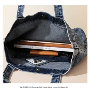 Spacious interior of blue denim tote bag showing large capacity for iPad and books