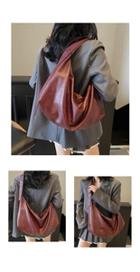 Close-up of a burgundy leather tote bag with a soft texture and spacious minimalist design