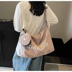Detail of mauve canvas tote bag with letter print and detachable mini coin purse