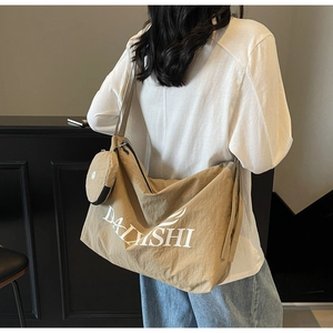 Detail view of khaki nylon tote bag with pleated design and matching mini coin purse pouch