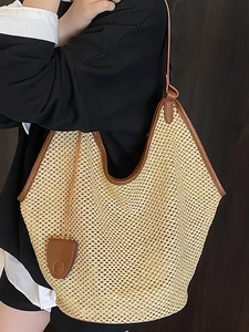 Summer woven straw bucket bag with brown leather trim and handle for beach trips