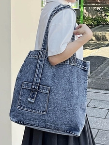 Chic washed blue denim tote bag for women featuring a minimalist street style design