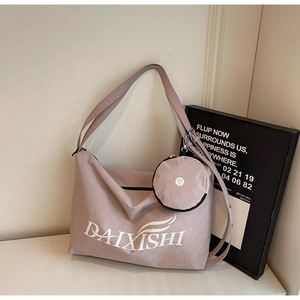 Detail of mauve tote bag with matching wide strap and a small round zip coin purse pouch