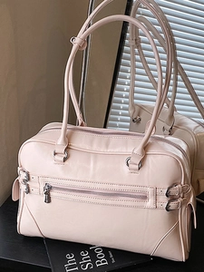 Pink minimalist bowling handbag with adjustable metal buckles and shoulder straps