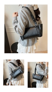 Détail du sac sous le bras en cuir noir minimaliste avec boucle de ceinture et œillets argentés