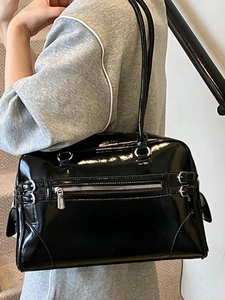 Minimalist black patent leather bowling bag with silver zipper and large shoulder straps