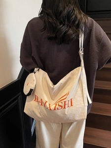 Large cream canvas crossbody bag with orange logo and round coin purse for daily use