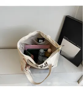 Spacious canvas tote interior showing tablet, umbrella, and essentials in organized compartments