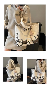 Detail of canvas tote bag with cartoon bear prints and cute brown plush bear charm