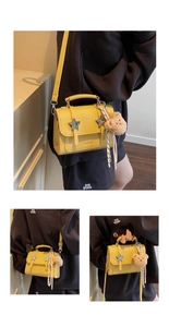 Detail of yellow crossbody bag with silver stars and plush bear charm decoration