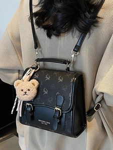Sac à dos vintage rétro en similicuir noir et marron avec un pendentif ours en peluche