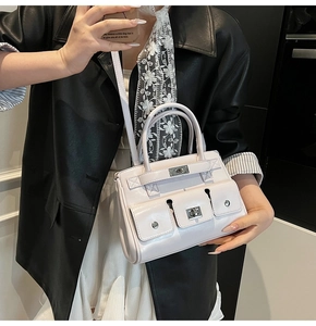 Close-up of lavender PU leather tote bag with three front pockets and silver studs