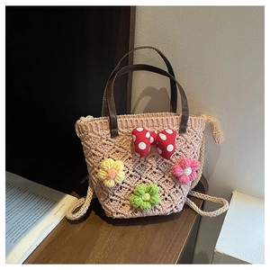 Close-up of handmade crochet bag featuring 3D floral accents and leather handles
