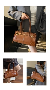 Close-up of vintage brown glossy leather tote bag with stylish buckle and stitching details