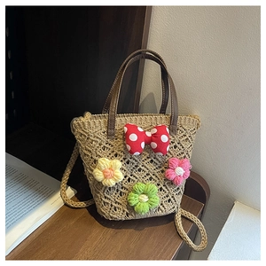 Close-up of handmade woven flower bucket bag featuring colorful 3D crochet floral details