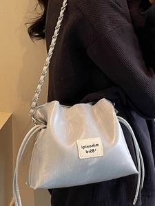 Silver pearlescent shell bucket bag with chain strap and drawstring closure for women