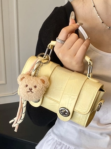 Pale yellow crocodile texture messenger bag with silver lock and plush bear pendant