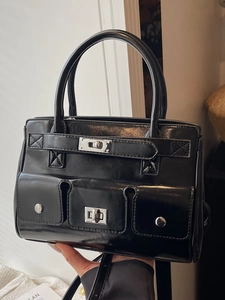Fashionable black patent leather tote bag with silver twist locks and versatile pockets
