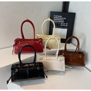 Front view of five shiny leather underarm bags in red, beige, brown, white, and black