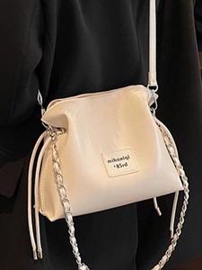 Chic cream seashell-shaped crossbody bag with drawstring and gold metal chain strap