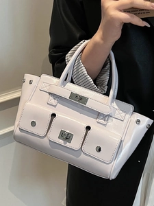 Pale pink leather tote bag with silver hardware and multi-pocket functional design