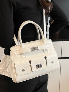 White glossy faux leather tote bag with three front flap pockets and metallic turn lock