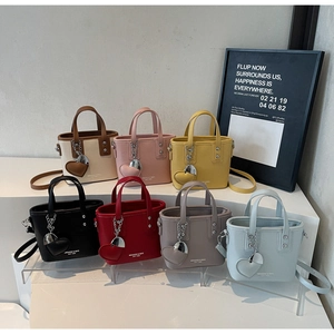 Detailed display of mini bucket bags in seven colors with leather heart charms