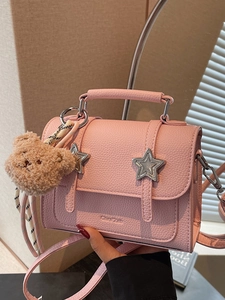 Pink lychee leather crossbody bag with silver stars and a cute plush bear charm