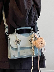 Light blue faux leather square handbag with star buckles and a plush bear charm strap