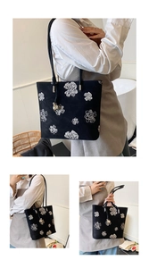Detail of a vintage Chinese style floral bucket bag with white embroidery and thin strap