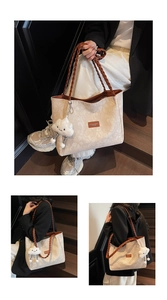 Detail of floral jacquard tote bag with braided brown strap and plush cloud charm