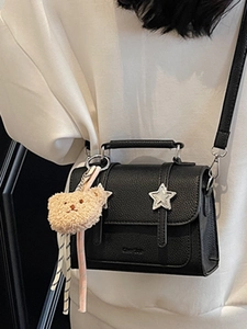 Black pebbled leather crossbody bag with silver star and cute bear charm pendant