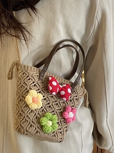 Floral woven straw handbag with red polka dot bow and crossbody strap for beach beachwear