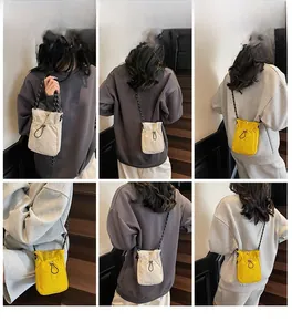 Detail view showing mini nylon drawstring crossbody bag with textured woven strap and cord lock