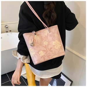 Detail of pink floral bucket bag with refined textures and elegant silver metal hardware