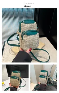 Detail of woven straw crossbody bag with green leather trim and adjustable strap