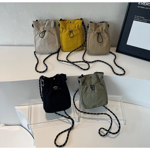 Mini nylon drawstring crossbody bags in five colors with woven adjustable straps